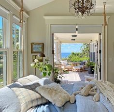 a bedroom with an ocean view is shown in this image, and the bed has pillows on it