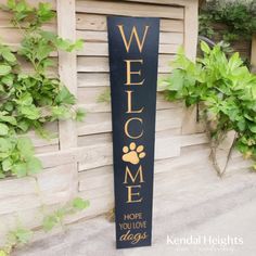 a welcome sign with a dog's paw on it