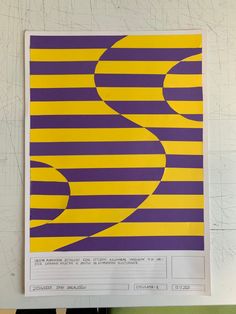 a yellow and purple striped poster hanging on a wall