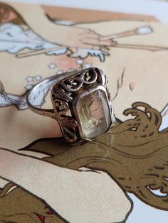 "A beautiful, German Jugendstil style silver Art Nouveau Citrine 835 silver ring. Circa 1920s. This item is vintage/antique, there is wear due to age. **This item is 8.75\" US** Jugendstil: (\"Youth Style\") was an artistic movement, particularly in the decorative arts, that was influential primarily in Germany and elsewhere in Europe to a lesser extent from about 1895 until about 1910. It was the German counterpart of Art Nouveau. The members of the movement were reacting against the historicism and neo-classicism of the official art and architecture academies. It took its name from the art journal Jugend, founded by the German artist Georg Hirth. It was especially active in the graphic arts and interior decoration. Basic info: Size- Approx. 8.75\" Color: Silver Type- Silver work weight- Vintage Silver Filigree Ring, Vintage Sterling Silver Filigree Ring, Antique Handmade Silver Rings, Handmade Antique Silver Vintage Rings, Antique Handmade Rings In Antique Silver, Handmade Antique Silver Engraved Ring, Handmade Vintage Antique Silver Rings, Vintage Silver Engraved Ring, Vintage Antique Silver Engraved Ring Stamped 925