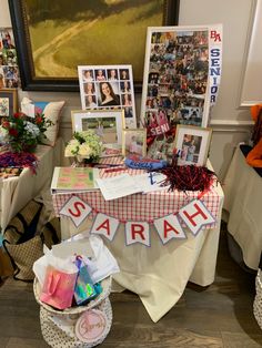 a table with pictures and flowers on it