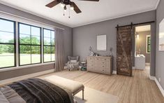 a bedroom with gray walls and wooden floors has a ceiling fan in the middle of the room