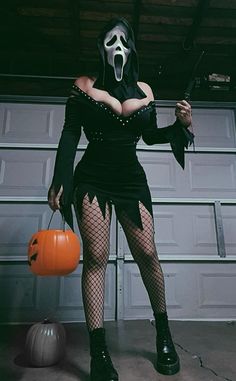 a woman dressed as a ghost with a pumpkin in her hand and holding a knife