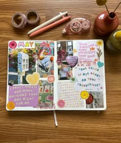 an open planner book sitting on top of a wooden table