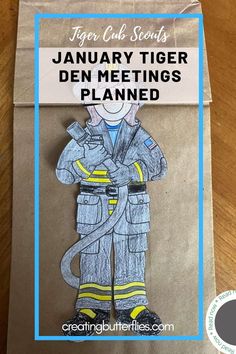 a paper bag with a drawing of a fireman on it and the words january tiger den meetings planned