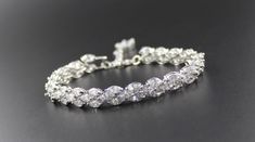 "'Felicity' Crystal Bridal Bracelet has been designed in a triple marquise style and will let your beautiful engagement and wedding rings take center stage. The CZ crystals are very high quality and look just like the real thing without the 'real' price tag. The sparkle on these is incredible. Set in a rhodium tarnish resistant base, Felicity is heirloom quality and can be worn again and again. We have closed it with a rhodium lobster clasp and small extender complete with a matching crystal for Marquise Bridal, Bridal Bracelets, Bracelet White Gold, Bracelet Wedding, Bracelet Crystal, Bangles Bracelets, Buy Crystals, Bridal Bracelet, Gold Crystal