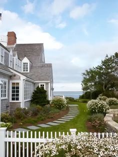 a white picket fence in front of a house