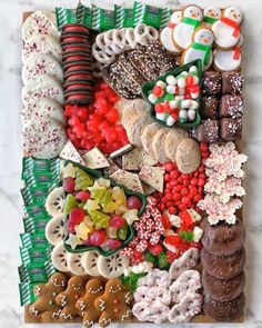 a platter filled with lots of different types of cookies and candys on top of a table