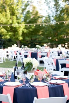 the tables are set for an outdoor wedding reception