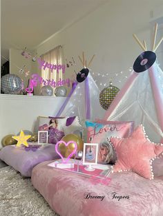 a bed with pink and purple decorations on it