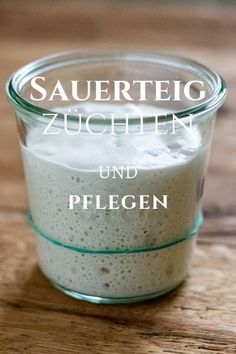 a glass jar filled with food on top of a wooden table