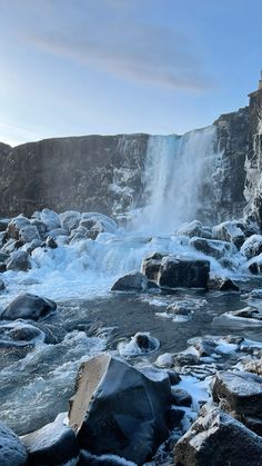 the water is rushing over the rocks and into the river to see if it's frozen