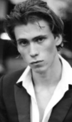 black and white photo of young man with cross on forehead