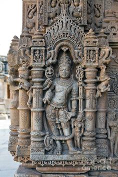 an intricately carved statue on display at the entrance to a hindu temple in india