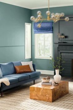 a living room filled with furniture and a fire place in front of a blue wall