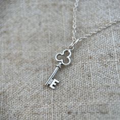 This is such a sweet little refurbished vintage sterling silver key pendant.  The key has a little initial 'E' on it. I have a few different letters and hearts so please check my other listings too.  A great little pendant to layer up. There are also a choice of chain lengths. Please choose from the drop down menu.  This item comes well packaged in a branded box and would make a lovely gift. A gift message can also be added upon request.  Returns policy -  If you would like to make a return, ple Silver Jewelry With Vintage Charm Initial Pendant, Silver Vintage Charm Jewelry With Initial Pendant, E Initial, Elegant Sterling Silver Key Necklace, Initial E, Nickel-free Sterling Silver Initial Pendant Charm Necklace, Silver Key, Key Pendant, Gift Message