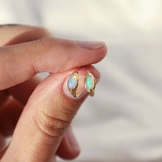 Take your everyday ear stack to the next level with these opal huggie hoops! Not only are they dainty and understated, but these little accessories also pack a punch— bejeweled with a crystal opal for a pop of iridescent color, they'll brighten up your lobes with just the right amount of sparkle. comes with a 14k gold classic earring back sold as a single hoop, unless you select a different quantity from the drop down menu hoops measure 9.7mm in diameter post is 20g made of solid 14k gold, so th Little Accessories, Iridescent Color, Ear Stack, Classic Earrings, Crystal Opal, Opal Crystal, Earring Backs, Opal, Fine Jewelry