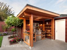 an outdoor kitchen is built into the side of a house