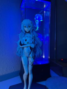 a doll is standing in front of a blue light