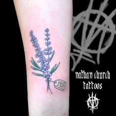 a small lavender tattoo on the arm