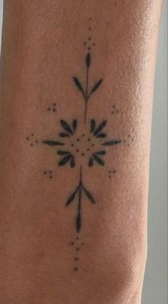 a black and white photo of a tattoo on someone's leg, with an arrow in the middle