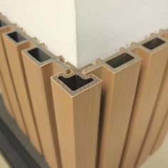 the corner of a building with several square sections on it's side, and one section is made out of plywood