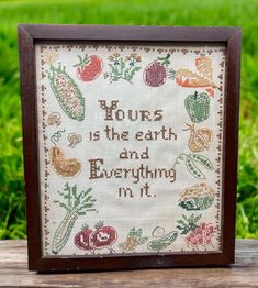 a cross stitch sample with the words yours is the earth and everything i'm it