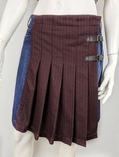 "Rare vintage denim wool skirt from Jean Paul Gaultier. Skirt kilt pleated tartan. The wrap skirt is fastened by a two black belt. Size I42 USA8 F38 (see measurements ) Condition 9/10 Color: blue denim and burgundy striped wool Made in Italy Waist - 39,5cm/15,55\" length skirt - 47,5cm/18,70\" All measurements taken with garment lying flat. Vintage sizes vary greatly! We recommend comparing measurements with a similar style garment you own for best fit! If you have any other questions, please co Jean Paul Gaultier Skirt, 90s Jean, Pleated Denim Skirt, Pleated Denim, Wool Mini Skirt, Recycle Jeans, Vintage Rock, Jeans Rock, Geek Chic