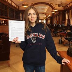 a woman is holding up a piece of paper