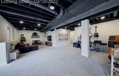 an empty living room with white walls and grey carpet