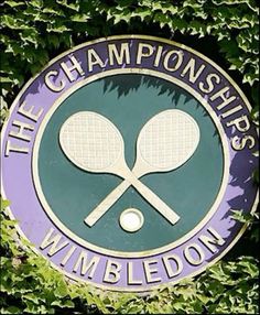 there is a purple and green sign with two tennis racquets on it