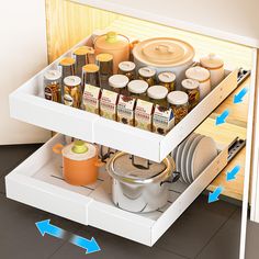 an open drawer in a kitchen with spices and condiments on the bottom shelf