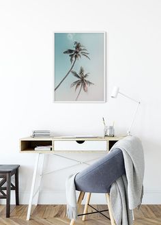 a chair sitting in front of a desk with two palm trees on it