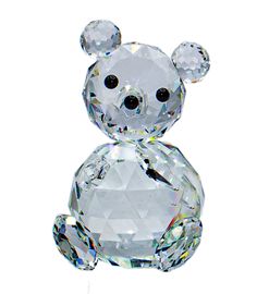 a crystal teddy bear sitting on top of a white surface