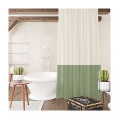 a white tub sitting next to a green shower curtain