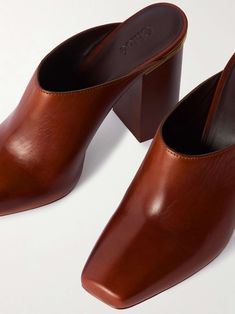 Luxury Slip-on Mules With Padded Heel, Chic Brown Calf Leather Mules, Elegant Brown Mules With Padded Heel, Chic Calf Leather Mules With Padded Heel, Formal Leather Mules With Padded Heel, Padded Heel Calf Leather Mules, Calf Leather Slip-on Heels For Office, Chic Leather Mules With Almond Toe, Chic Leather Almond Toe Mules