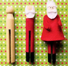 two wooden peg dolls are standing next to each other with santa's hats on