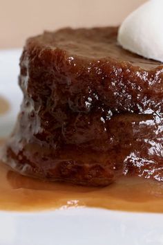 a piece of chocolate cake on a plate with whipped cream