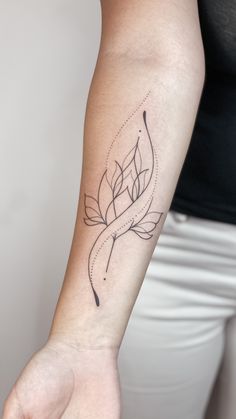 a woman's arm with a tattoo on it that has an arrow in the center