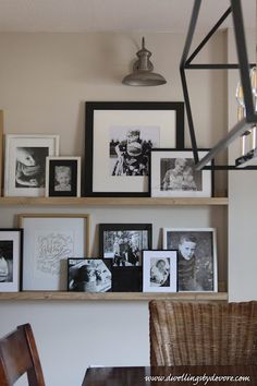 the shelves are filled with pictures and framed photographs