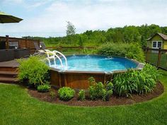 an above ground pool surrounded by lush green grass