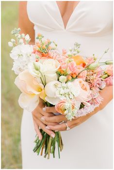 a woman holding a bouquet of flowers in her hands