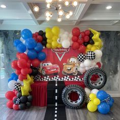 a birthday party setup with balloons and cars