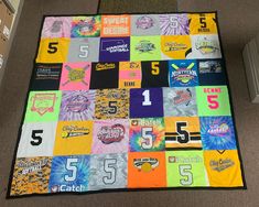 a quilt made out of t - shirts on the floor