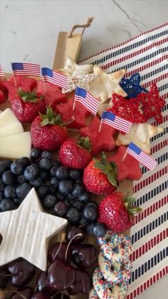 an american flag platter with cheese, fruit and crackers on the side for fourth of july