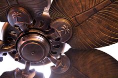 an overhead view of a ceiling fan with leaves on it