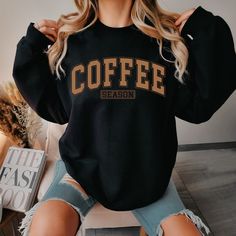 Indulge your passion for the rich aroma and comforting warmth of coffee with our exclusive Coffee Crewneck Sweatshirt. Embrace the cozy vibes of winter in style with this must-have coffee lover sweatshirt, meticulously designed for ultimate comfort and warmth. Crafted from premium materials, this coffee sweater is perfect for the chilly season, making it the ideal winter crewneck sweatshirt for any coffee aficionado. Whether you're a dedicated coffee drinker or simply enjoy the occasional cup, this coffee sweatshirt is a fashionable expression of your love for the beloved beverage. Elevate your winter wardrobe with this statement piece that seamlessly blends comfort and style, ensuring you stay snug while flaunting your passion for coffee. Upgrade your seasonal attire with our Coffee Crewn Coffee Shop Shirt Ideas, Coffee Graphic Tee With Crew Neck, Casual Coffee Sweatshirt For Winter, Crewnecks For Women, Coffee Crew Neck Sweatshirt For Winter, Crew Neck Sweatshirt Outfit, Fall Coffee Cotton Sweatshirt, Fall Style Casual, Coffee Crewneck