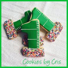 decorated cookies in the shape of an american football player with sprinkles on them