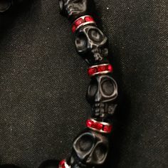 "If you're like me, you love skulls. So show your love with this skull bracelet! This bracelet features black howlite stone skulls and red stone crystal spacers, and is closed with a silver stainless steel lobster claw clasp. It comes in 3 sizes: Large - Fits wrists you to 7 1/2\" around Medium - Fits wrists up to 6 1/2\" around Small - Fits wrists up to 5 1/2\" around. If you need a different size, let me know and I will see what I can do. Make sure to check out my shop, PopBangBoom, for all so Red Gems, Skull Beads, Red Jewel, Howlite Stone, Skull Bracelet, Black Skulls, Beaded Skull, Goth Punk, Crystal Skull