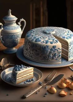 a blue and white cake sitting on top of a table next to a tea pot